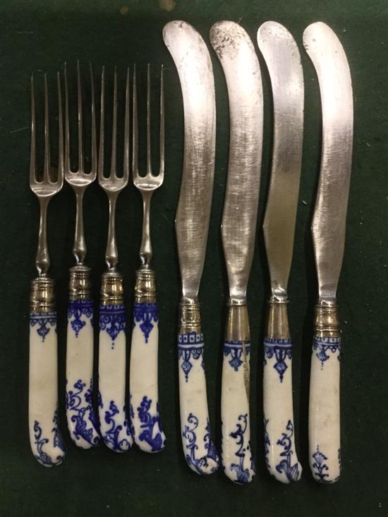 A set of 4 German porcelain handled carving knives and forks